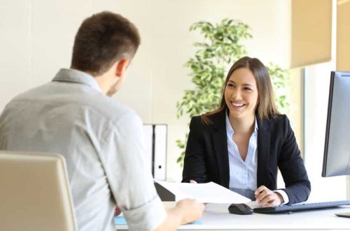 Guy giving a curriculum vitae to his interviewer in a job interview